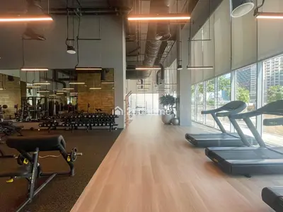 a gym with treadmills and exercising equipment in a room at Unit Overlooking Burj Khalifa and Fountain View in Dubai
