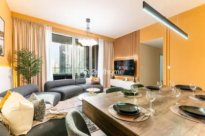 a living room with a table and a couch at Unit Overlooking Burj Khalifa and Fountain View in Dubai