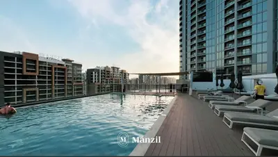 a swimming pool on the roof of a building at 1BR Apartment in Sobha Hartland with Skyline Views in Dubai