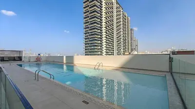 a large swimming pool on top of a building at Sky-High Serenity - Stylish 1BHK - 20th Floor in Dubai