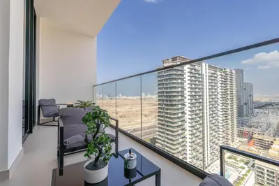 a balcony with a view of a tall building at Sky-High Serenity - Stylish 1BHK - 20th Floor in Dubai