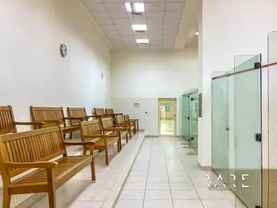 a row of wooden benches in a waiting room at Rare Holiday Homes - Marina Quays West Tower - Near the Beach - R1003 - Dubai Marina in Dubai