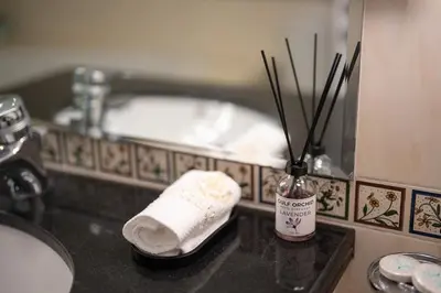 a bathroom with a sink and a towel and a mirror at Damac Waves Tower Dubai Marina - By Home Of Choice in Dubai
