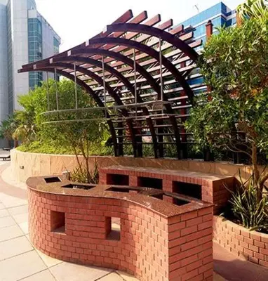 a brick fire pit in front of a building at Damac Waves Tower Dubai Marina - By Home Of Choice in Dubai