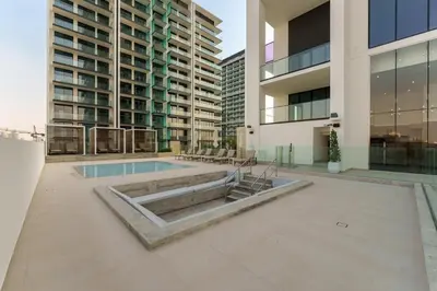 a pool in the middle of a building at Chic 1-Bedroom in Binghatti House JVC in Dubai