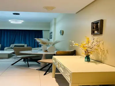 a living room with a table and chairs at MontRose residence Tower A 1BR Apartment in Dubai