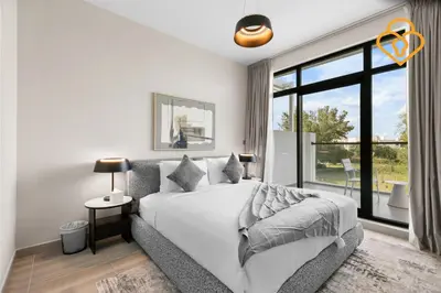 a bedroom with a bed and a large window at Keysplease 4BR, Nanny room, BBQ, Garden, Malibu Beach Access, Damac Hills in Dubai