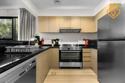 a kitchen with a stainless steel refrigerator and a sink at Keysplease 4BR, Nanny room, BBQ, Garden, Malibu Beach Access, Damac Hills in Dubai