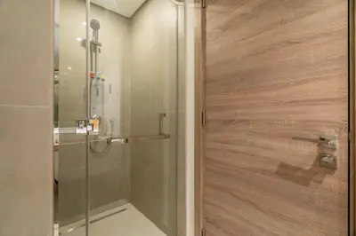 a shower with a glass door in a bathroom at GuestReady - Exquisite living with Marina views in Dubai