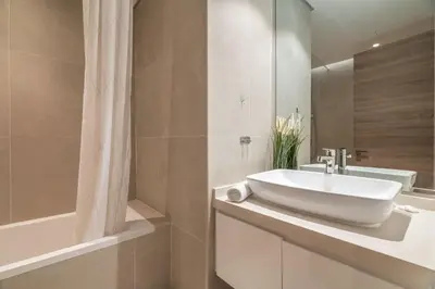 a bathroom with a sink and a bathtub and a sink at GuestReady - Exquisite living with Marina views in Dubai