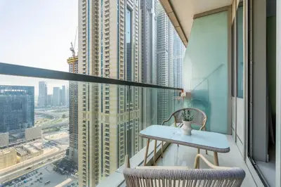 a table and two chairs on a balcony in a building at GuestReady - Contemporary living in Dubai Marina in Dubai