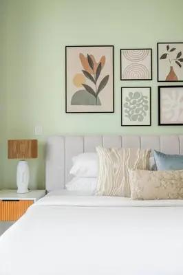 a bedroom with a white bed and framed pictures on the wall at GuestReady - Contemporary living in Dubai Marina in Dubai