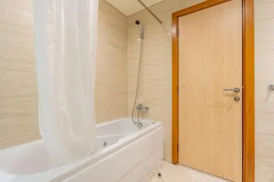 a bathroom with a white tub and a shower at GuestReady - Contemporary living in Dubai Marina in Dubai