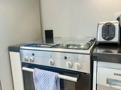 a kitchen with a stove with a towel on it at Modern Studio in Business Bay Capital Bay Tower in Dubai