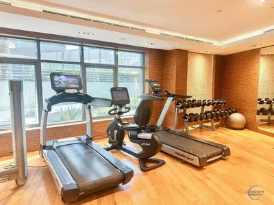 a gym with three treadmills and several exercise bikes at Modern Studio in Business Bay Capital Bay Tower in Dubai
