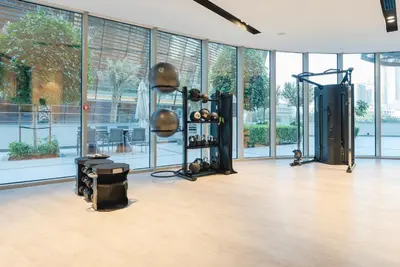 a room with a gym with a lot of windows at Downtown Luxury - Elegant 1-Bedroom Apartment - 5 Minutes Walk to Dubai Mall in Dubai