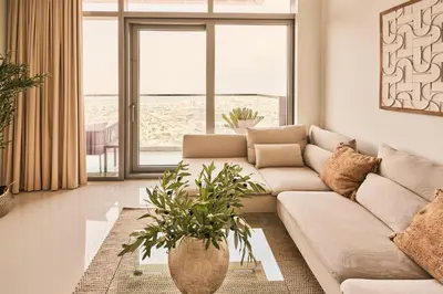 a living room with a couch and a large window at Paramount - Luxury 2BR Apartments with Burj and Sea Views - Access to the Infinity Pool on 64th Floor in Dubai