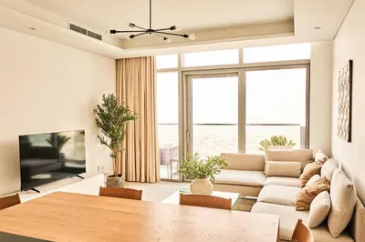 a living room with a couch and a table at Paramount - Luxury 2BR Apartments with Burj and Sea Views - Access to the Infinity Pool on 64th Floor in Dubai