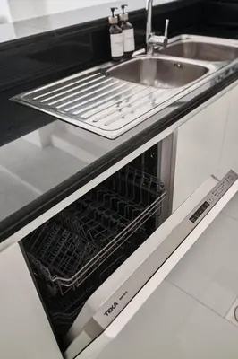 an open oven with a sink in a kitchen at Paramount - Luxury 2BR Apartments with Burj and Sea Views - Access to the Infinity Pool on 64th Floor in Dubai