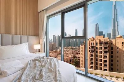 a bedroom with a bed and a large window at Full Burj Khalifa View! Brand New 2 Bedrooms! 5min walk From Dubai Mall! in Dubai