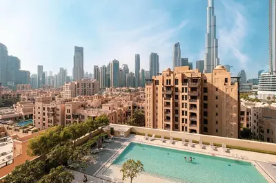 a large swimming pool on top of a building with a city at Full Burj Khalifa View! Brand New 2 Bedrooms! 5min walk From Dubai Mall! in Dubai