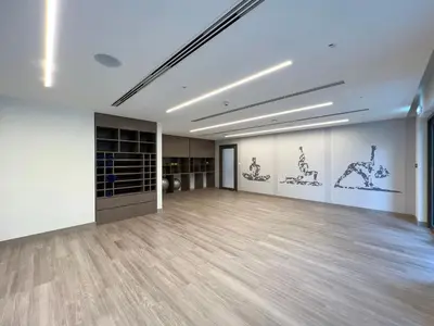 a large room with a wooden floor and paintings on the walls at Full Burj Khalifa View! Brand New 2 Bedrooms! 5min walk From Dubai Mall! in Dubai