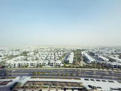 an aerial view of a city with white buildings at Luxe Escape at Dubai Hills in Dubai