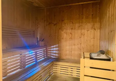 an empty wooden sauna with a blue light in it at HiGuests - Vibrant 1BR in Business Bay in Dubai