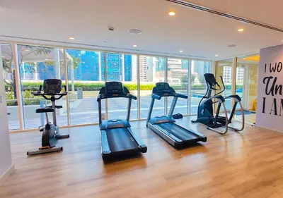 a gym with several treadmills in a room at HiGuests - Vibrant 1BR in Business Bay in Dubai