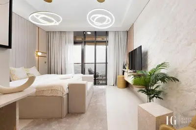 a bedroom with a king sized bed and a tv at Sky-High Aykon City Studio in Dubai