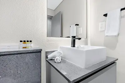 a bathroom with a white sink and a mirror at Luxury 1BR City View with Balcony Parking & WiFi Near Dining & Downtown in Dubai