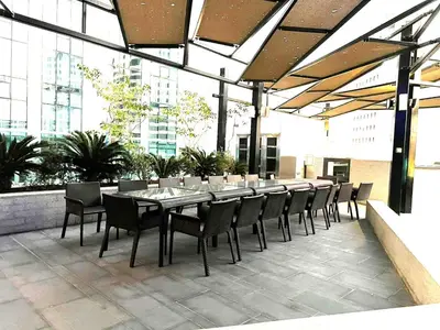 a dining table and chairs on an outdoor patio at Downtown 1BR - 5 minutes to mall - panoramic pool in Dubai