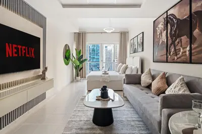 a living room with a couch and a table at Modern Studio Apartment in Lake View in Dubai