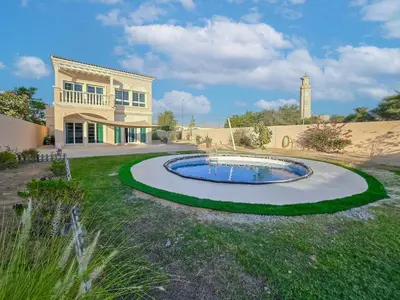 a house with a small pool in the yard at Private Pool Villa In Jvc in Dubai