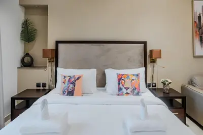 a bedroom with a large white bed with pillows at Clever Guest 002 Elite Downtown in Dubai