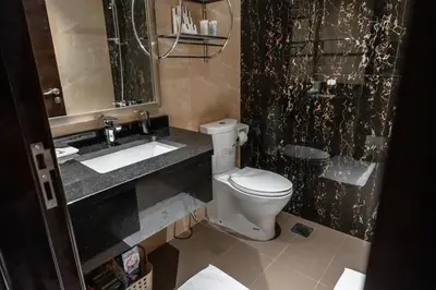 a bathroom with a white toilet and a sink at Clever Guest 002 Elite Downtown in Dubai