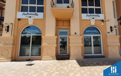 a building with windows and doors on a street at Huge Exclusive Comfortable Studio With Canal View! in Dubai