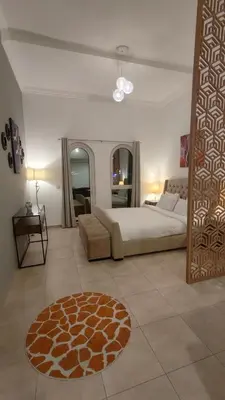a bedroom with a bed and a rug on the floor at Huge Exclusive Comfortable Studio With Canal View! in Dubai