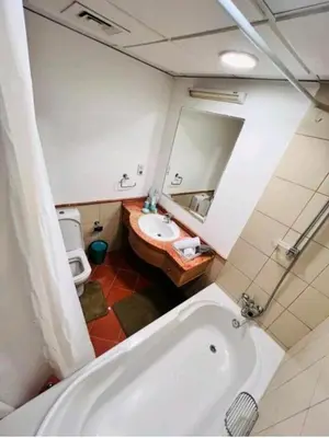 a bathroom with a tub and a sink and a mirror at Huge Exclusive Comfortable Studio With Canal View! in Dubai