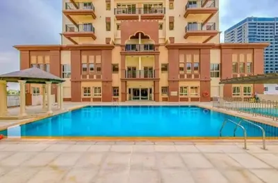 a building with a large swimming pool in front of a building at Huge Exclusive Comfortable Studio With Canal View! in Dubai