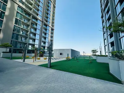 a courtyard in a large building with a playground at Creek Views 1 BR, Mins to Downtown in Sobha Creek Vistas in Dubai