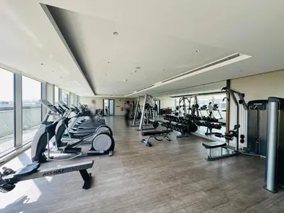 a gym with a bunch of treadmills and machines at Creek Views 1 BR, Mins to Downtown in Sobha Creek Vistas in Dubai