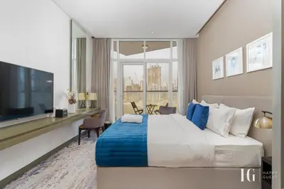 a bedroom with a large bed and a large window at Spacious Studio in Damac Maison Prive Canal Views in Dubai