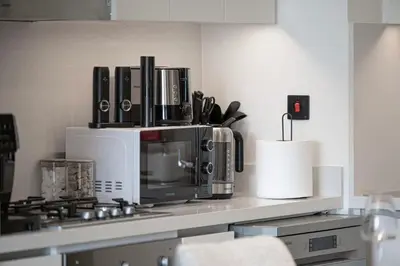 a kitchen counter with a microwave and a stove at Luxury 2BR Burj Khalifa View Dubai Mall in Dubai