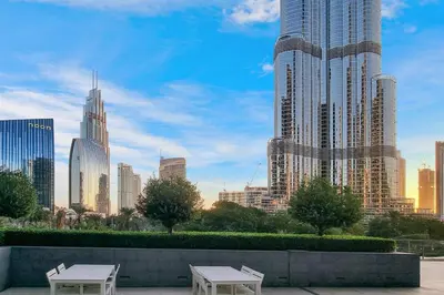 two picnic tables in front of a city skyline at FIRST CLASS 3BR Burj Khalifa & Fountain View in Dubai