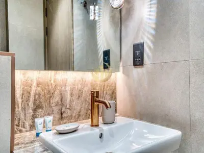 a bathroom with a sink and a mirror at Luxury 1BR Larger Layout Westwood Grande - 1103 in Dubai