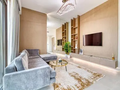 a living room with a couch and a tv at Luxury 1BR Larger Layout Westwood Grande - 1103 in Dubai