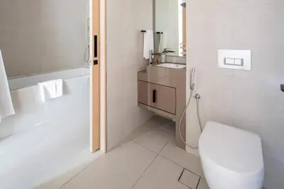 a white bathroom with a toilet and a sink at Frank Porter - Address JBR in Dubai