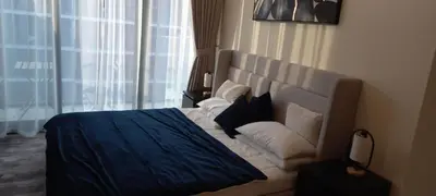 a hotel room with a bed and a couch at Studio Uni at Azizi Riviera 43 Near Business Bay in Dubai