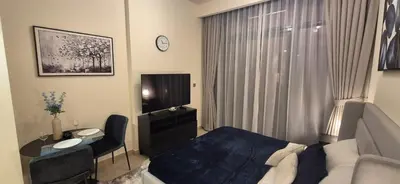 a hotel room with a bed and a desk and a television at Studio Uni at Azizi Riviera 43 Near Business Bay in Dubai